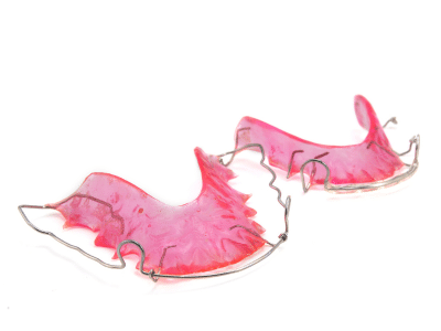 Pink and metal dental retainer | Nudera Orthodontics