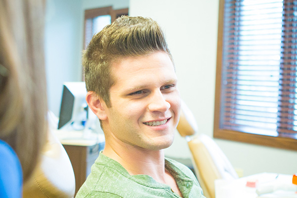 Young man smiling in clinic | Nudera Orthodontics