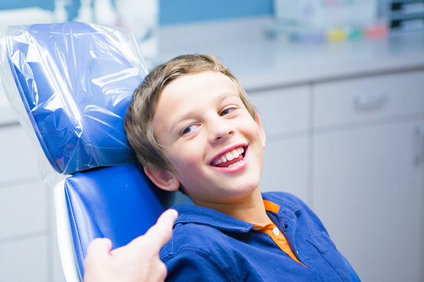 Boy in dental chair laughing | Nudera Orthodontics