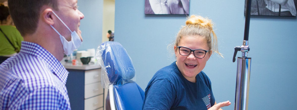 Young girl with glasses smiling | Nudera Orthodontics