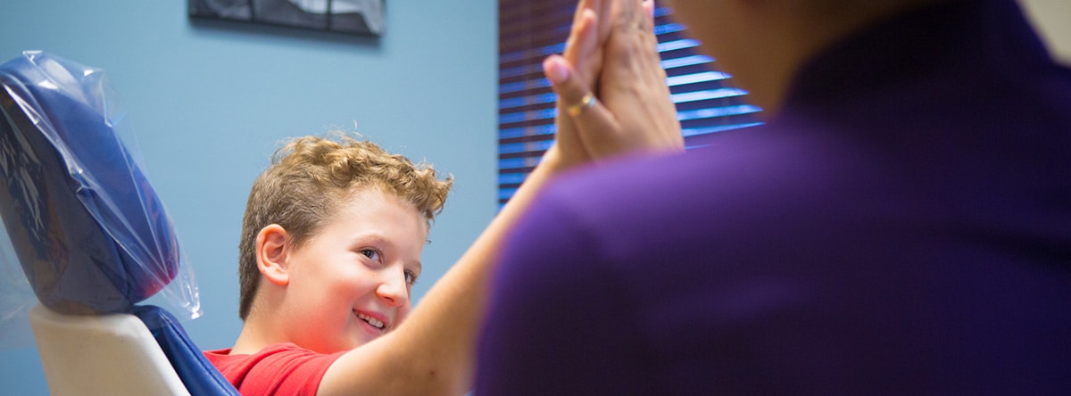 Young boy giving a high five | Nudera Orthodontics